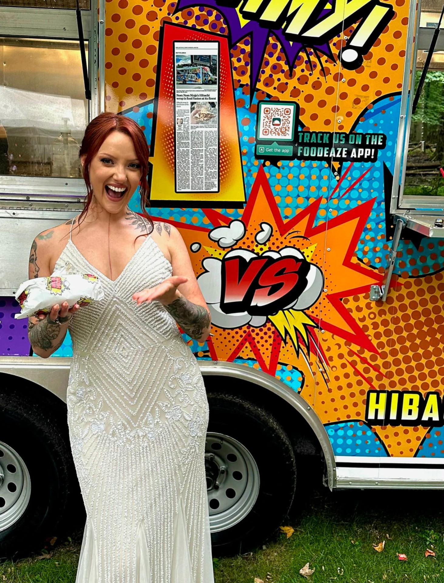 Bride holding a Nom Nom Ninja hibachi wrap in front of the food truck